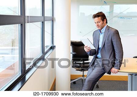 Businessman using tablet computer View Large Photo Image Stock Image - Businessman using tablet computer. Fotosearch