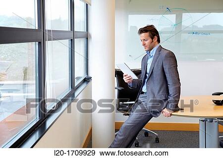 Stock Photo - Businessman using tablet computer. Fotosearch