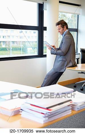 Stock Photography - Businessman using tablet computer. Fotosearch