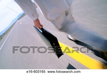 Businessman walking down road View Large Photo Image Stock Photography - Businessman walking down road. Fotosearch