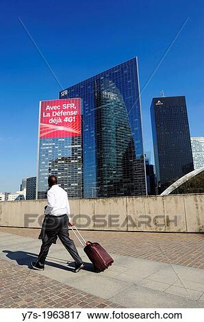 Businessman walking in the main square of La Defense district in the westernmost part of Paris, France, Europe. View Large Photo Image Stock Photo - Businessman walking in the main square of La Defense district in the westernmost part of Paris, France, Europe.. Fotosearch
