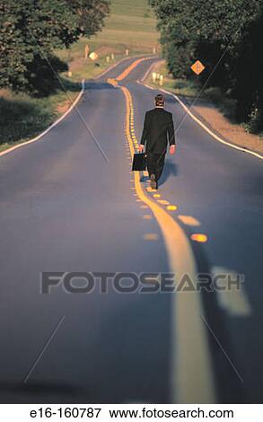 Businessman walking on long road View Large Photo Image Stock Photo - Businessman walking on long road. Fotosearch