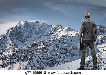 Businessman watching a mountain range. View Large Photo Image Stock Photo - Businessman watching a mountain range.. Fotosearch