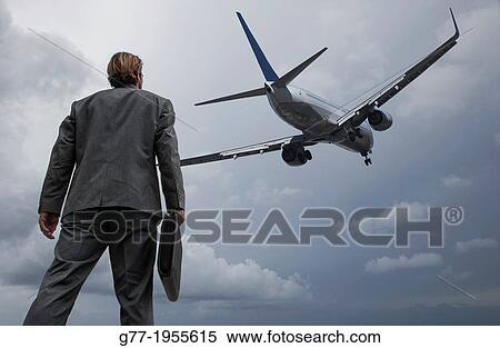 Businessman watching a plane taking off. Miami, USA View Large Photo Image Stock Photography - Businessman watching a plane taking off. Miami, USA. Fotosearch