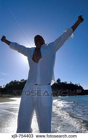 Stock Image - Businessman who relaxes on the beach.. Fotosearch