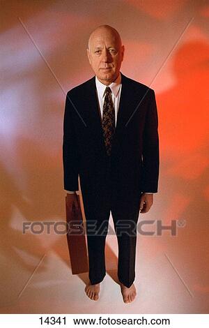 Stock Image - Businessman with bare feet. Fotosearch
