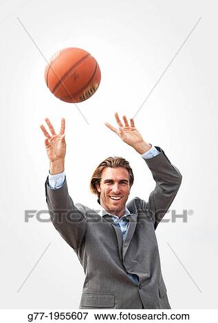 Stock Photo - Businessman with basketball. New York, USA. Fotosearch