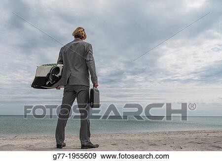 Businessman with briefcase and surfboard on the beach. Miami, USA View Large Photo Image Stock Photo - Businessman with briefcase and surfboard on the beach. Miami, USA. Fotosearch