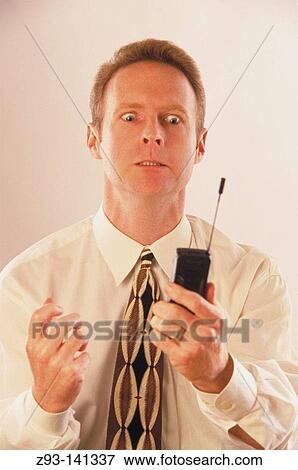 Businessman with cell phone suffering a nervous breakdown View Large Photo Image Stock Photo - Businessman with cell phone suffering a nervous breakdown. Fotosearch