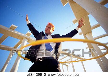 Businessman with hula-hoop View Large Photo Image Stock Image - Businessman with hula-hoop. Fotosearch