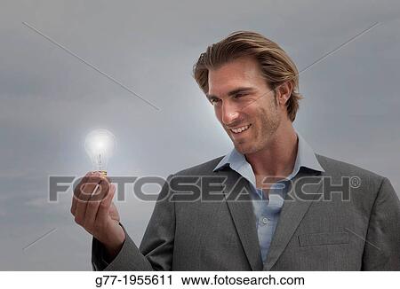 Businessman with light bulb Miami, USA View Large Photo Image Stock Image - Businessman with light bulb Miami, USA. Fotosearch