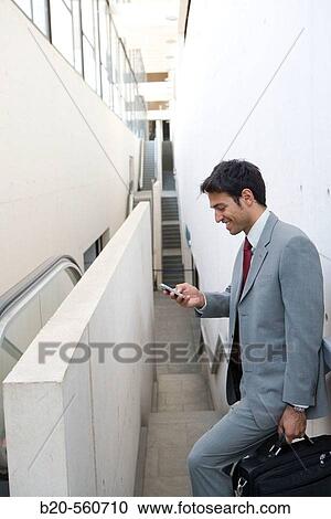 Businessman with mobile phone. Delicias station, Zaragoza, Arag? n. Spain. View Large Photo Image Stock Image - Businessman with mobile phone. Delicias station, Zaragoza, Arag? n. Spain.. Fotosearch