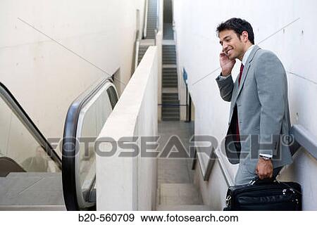 Businessman with mobile phone. Delicias station, Zaragoza, Arag? n. Spain. View Large Photo Image Stock Photo - Businessman with mobile phone. Delicias station, Zaragoza, Arag? n. Spain.. Fotosearch