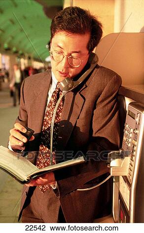 Businessman with pager, on pay phone at airport terminal. Los Angeles. California. USA View Large Photo Image Stock Image - Businessman with pager, on pay phone at airport terminal. Los Angeles. California. USA. Fotosearch