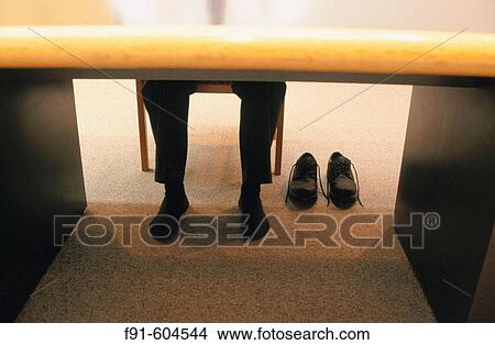 Businessman with shoes off View Large Photo Image Picture - Businessman with shoes off. Fotosearch