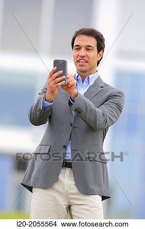Businessman with smartphone business center. San Sebastian Technology Park. Donostia. Gipuzkoa. Basque Country. Spain. View Large Photo Image Picture - Businessman with smartphone business center. San Sebastian Technology Park. Donostia. Gipuzkoa. Basque Country. Spain.. Fotosearch