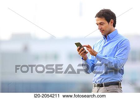 Businessman with smartphone business center. San Sebastian Technology Park. Donostia. Gipuzkoa. Basque Country. Spain. View Large Photo Image Stock Image - Businessman with smartphone business center. San Sebastian Technology Park. Donostia. Gipuzkoa. Basque Country. Spain.. Fotosearch