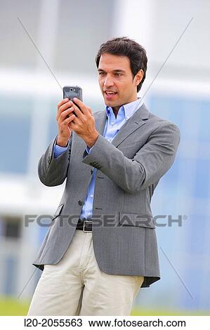 Businessman with smartphone business center. San Sebastian Technology Park. Donostia. Gipuzkoa. Basque Country. Spain. View Large Photo Image Stock Image - Businessman with smartphone business center. San Sebastian Technology Park. Donostia. Gipuzkoa. Basque Country. Spain.. Fotosearch