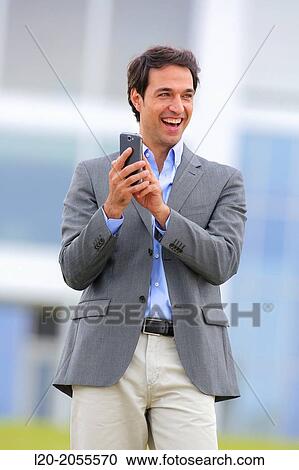 Businessman with smartphone business center. San Sebastian Technology Park. Donostia. Gipuzkoa. Basque Country. Spain. View Large Photo Image Stock Image - Businessman with smartphone business center. San Sebastian Technology Park. Donostia. Gipuzkoa. Basque Country. Spain.. Fotosearch