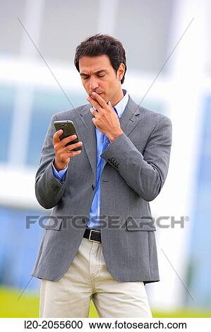Businessman with smartphone business center. San Sebastian Technology Park. Donostia. Gipuzkoa. Basque Country. Spain. View Large Photo Image Stock Image - Businessman with smartphone business center. San Sebastian Technology Park. Donostia. Gipuzkoa. Basque Country. Spain.. Fotosearch