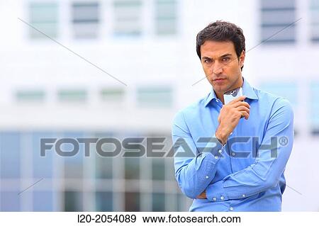 Businessman with smartphone business center. San Sebastian Technology Park. Donostia. Gipuzkoa. Basque Country. Spain. View Large Photo Image Stock Photo - Businessman with smartphone business center. San Sebastian Technology Park. Donostia. Gipuzkoa. Basque Country. Spain.. Fotosearch
