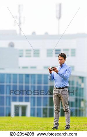 Businessman with smartphone business center. San Sebastian Technology Park. Donostia. Gipuzkoa. Basque Country. Spain. View Large Photo Image Stock Photo - Businessman with smartphone business center. San Sebastian Technology Park. Donostia. Gipuzkoa. Basque Country. Spain.. Fotosearch