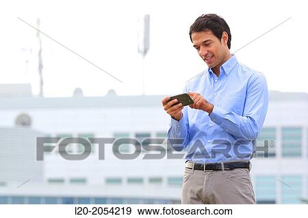 Businessman with smartphone business center. San Sebastian Technology Park. Donostia. Gipuzkoa. Basque Country. Spain. View Large Photo Image Stock Photo - Businessman with smartphone business center. San Sebastian Technology Park. Donostia. Gipuzkoa. Basque Country. Spain.. Fotosearch