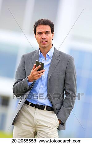 Businessman with smartphone business center. San Sebastian Technology Park. Donostia. Gipuzkoa. Basque Country. Spain. View Large Photo Image Stock Photo - Businessman with smartphone business center. San Sebastian Technology Park. Donostia. Gipuzkoa. Basque Country. Spain.. Fotosearch