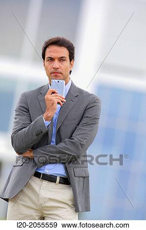 Businessman with smartphone business center. San Sebastian Technology Park. Donostia. Gipuzkoa. Basque Country. Spain. View Large Photo Image Stock Photo - Businessman with smartphone business center. San Sebastian Technology Park. Donostia. Gipuzkoa. Basque Country. Spain.. Fotosearch