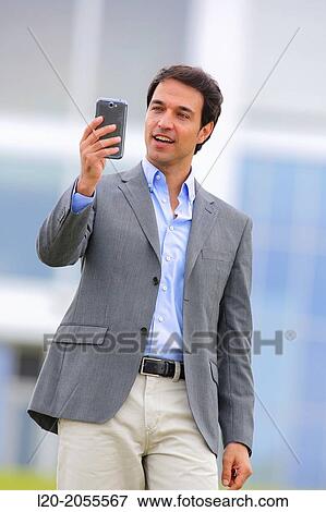 Stock Photo - Businessman with smartphone business center. San Sebastian Technology Park. Donostia. Gipuzkoa. Basque Country. Spain.. Fotosearch