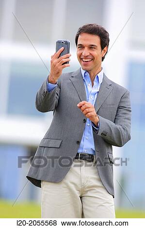 Businessman with smartphone business center. San Sebastian Technology Park. Donostia. Gipuzkoa. Basque Country. Spain. View Large Photo Image Stock Photo - Businessman with smartphone business center. San Sebastian Technology Park. Donostia. Gipuzkoa. Basque Country. Spain.. Fotosearch
