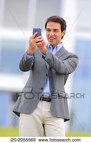 Businessman with smartphone business center. San Sebastian Technology Park. Donostia. Gipuzkoa. Basque Country. Spain. View Large Photo Image Stock Photo - Businessman with smartphone business center. San Sebastian Technology Park. Donostia. Gipuzkoa. Basque Country. Spain.. Fotosearch