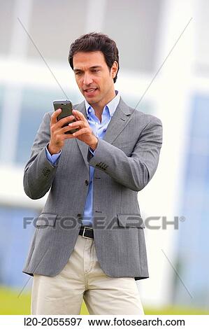 Businessman with smartphone business center. San Sebastian Technology Park. Donostia. Gipuzkoa. Basque Country. Spain. View Large Photo Image Stock Photo - Businessman with smartphone business center. San Sebastian Technology Park. Donostia. Gipuzkoa. Basque Country. Spain.. Fotosearch
