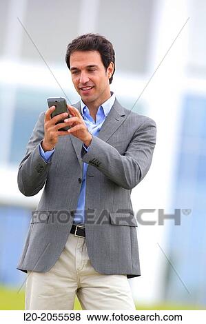Businessman with smartphone business center. San Sebastian Technology Park. Donostia. Gipuzkoa. Basque Country. Spain. View Large Photo Image Stock Photo - Businessman with smartphone business center. San Sebastian Technology Park. Donostia. Gipuzkoa. Basque Country. Spain.. Fotosearch