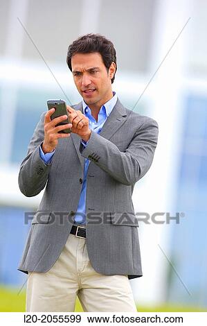 Businessman with smartphone business center. San Sebastian Technology Park. Donostia. Gipuzkoa. Basque Country. Spain. View Large Photo Image Stock Photo - Businessman with smartphone business center. San Sebastian Technology Park. Donostia. Gipuzkoa. Basque Country. Spain.. Fotosearch