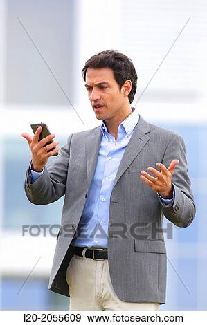 Businessman with smartphone business center. San Sebastian Technology Park. Donostia. Gipuzkoa. Basque Country. Spain. View Large Photo Image Stock Photo - Businessman with smartphone business center. San Sebastian Technology Park. Donostia. Gipuzkoa. Basque Country. Spain.. Fotosearch