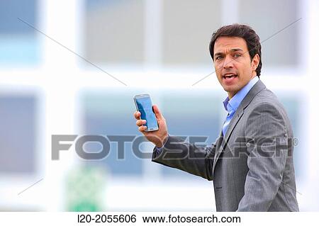 Businessman with smartphone business center. San Sebastian Technology Park. Donostia. Gipuzkoa. Basque Country. Spain. View Large Photo Image Stock Photograph - Businessman with smartphone business center. San Sebastian Technology Park. Donostia. Gipuzkoa. Basque Country. Spain.. Fotosearch