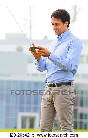 Businessman with smartphone business center. San Sebastian Technology Park. Donostia. Gipuzkoa. Basque Country. Spain. View Large Photo Image Stock Photography - Businessman with smartphone business center. San Sebastian Technology Park. Donostia. Gipuzkoa. Basque Country. Spain.. Fotosearch