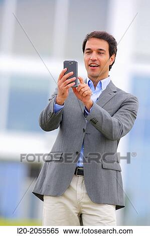 Businessman with smartphone business center. San Sebastian Technology Park. Donostia. Gipuzkoa. Basque Country. Spain. View Large Photo Image Stock Photography - Businessman with smartphone business center. San Sebastian Technology Park. Donostia. Gipuzkoa. Basque Country. Spain.. Fotosearch