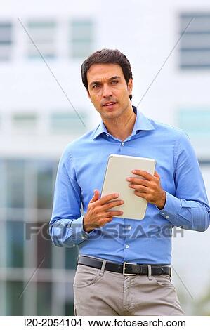 Businessman with tablet in business center. San Sebastian Technology Park. Donostia. Gipuzkoa. Basque Country. Spain. View Large Photo Image Picture - Businessman with tablet in business center. San Sebastian Technology Park. Donostia. Gipuzkoa. Basque Country. Spain.. Fotosearch