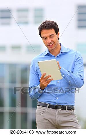 Stock Image - Businessman with tablet in business center. San Sebastian Technology Park. Donostia. Gipuzkoa. Basque Country. Spain.. Fotosearch