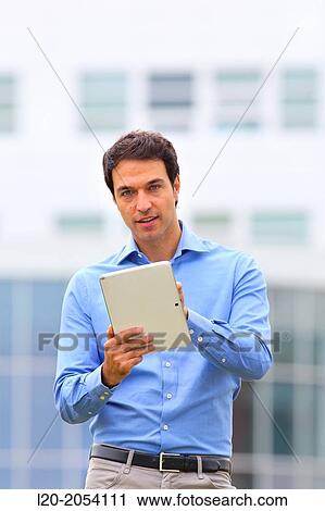Businessman with tablet in business center. San Sebastian Technology Park. Donostia. Gipuzkoa. Basque Country. Spain. View Large Photo Image Stock Image - Businessman with tablet in business center. San Sebastian Technology Park. Donostia. Gipuzkoa. Basque Country. Spain.. Fotosearch