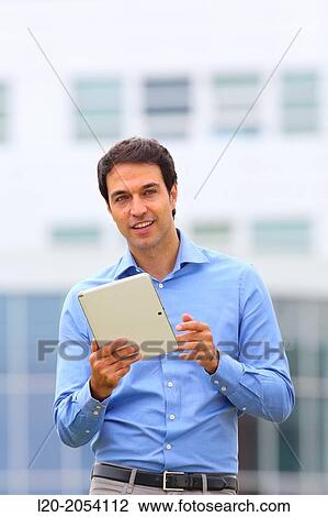 Businessman with tablet in business center. San Sebastian Technology Park. Donostia. Gipuzkoa. Basque Country. Spain. View Large Photo Image Stock Image - Businessman with tablet in business center. San Sebastian Technology Park. Donostia. Gipuzkoa. Basque Country. Spain.. Fotosearch