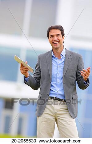 Businessman with tablet in business center. San Sebastian Technology Park. Donostia. Gipuzkoa. Basque Country. Spain. View Large Photo Image Stock Image - Businessman with tablet in business center. San Sebastian Technology Park. Donostia. Gipuzkoa. Basque Country. Spain.. Fotosearch