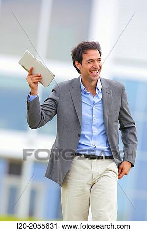 Businessman with tablet in business center. San Sebastian Technology Park. Donostia. Gipuzkoa. Basque Country. Spain. View Large Photo Image Stock Image - Businessman with tablet in business center. San Sebastian Technology Park. Donostia. Gipuzkoa. Basque Country. Spain.. Fotosearch