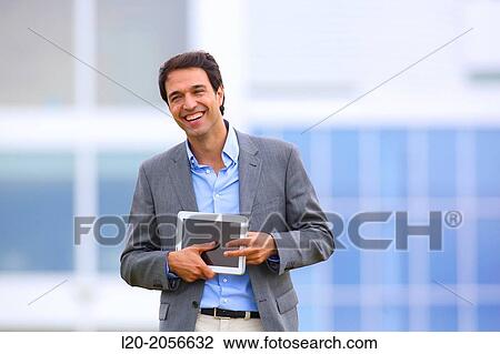 Businessman with tablet in business center. San Sebastian Technology Park. Donostia. Gipuzkoa. Basque Country. Spain. View Large Photo Image Stock Image - Businessman with tablet in business center. San Sebastian Technology Park. Donostia. Gipuzkoa. Basque Country. Spain.. Fotosearch