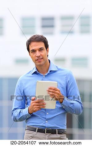 Businessman with tablet in business center. San Sebastian Technology Park. Donostia. Gipuzkoa. Basque Country. Spain. View Large Photo Image Stock Photo - Businessman with tablet in business center. San Sebastian Technology Park. Donostia. Gipuzkoa. Basque Country. Spain.. Fotosearch