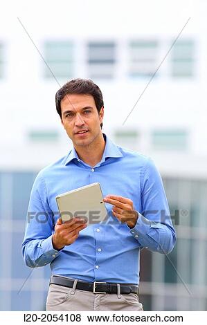 Businessman with tablet in business center. San Sebastian Technology Park. Donostia. Gipuzkoa. Basque Country. Spain. View Large Photo Image Stock Photo - Businessman with tablet in business center. San Sebastian Technology Park. Donostia. Gipuzkoa. Basque Country. Spain.. Fotosearch