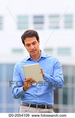 Stock Photo - Businessman with tablet in business center. San Sebastian Technology Park. Donostia. Gipuzkoa. Basque Country. Spain.. Fotosearch