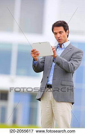 Businessman with tablet in business center. San Sebastian Technology Park. Donostia. Gipuzkoa. Basque Country. Spain. View Large Photo Image Stock Photo - Businessman with tablet in business center. San Sebastian Technology Park. Donostia. Gipuzkoa. Basque Country. Spain.. Fotosearch